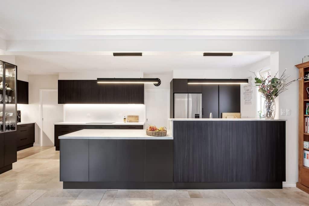 Beautiful white kitchen renovation with dark tone accents.