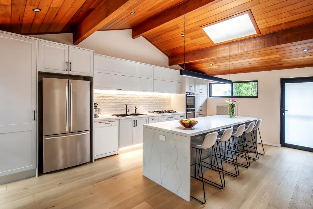 Gorgeous kitchen renovation with skylights and wooden accent ceiling