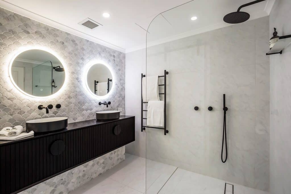 Stunning bathroom renovation with circular mirrors